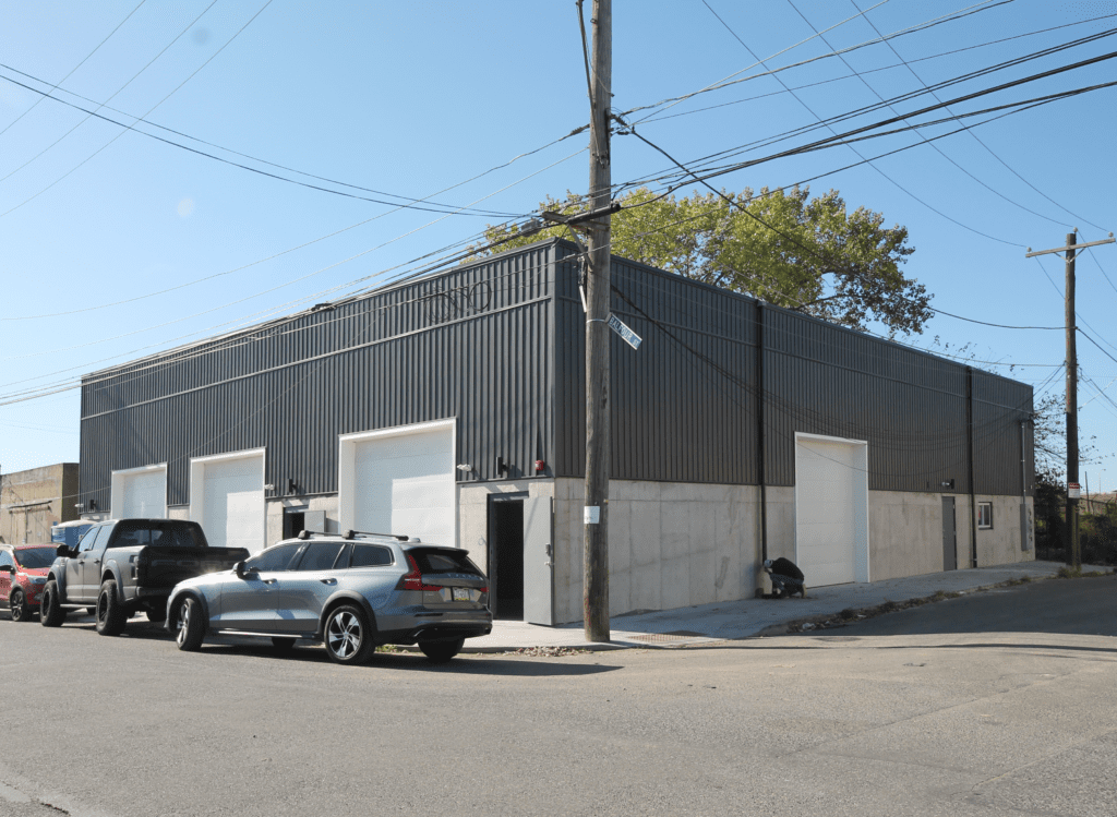 The building's exterior is clad in simple concrete block and steel siding.